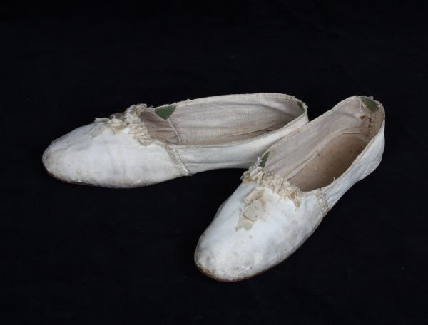 A pair of off-white, kid leather women's shoes with shirred ribbon decoration on the top. They were most likely worn by Sylvia (Putnam) Hamilton (donor Grace Hamilton Frackleton's paternal great-grandmother) at her wedding on February 11, 1811 in Cobleskill, New York.
From the Wisconsin Historical Museum collection (1946.703a-b).