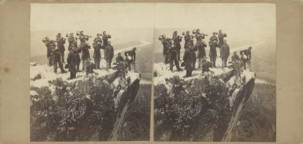 Albumen stereograph of the Union Army brass band posed and playing atop Lookout Point. The Tennessee River is in the background.