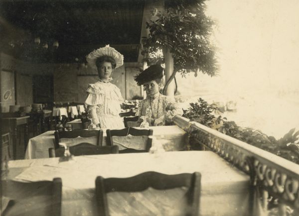Young Sigrid Schultz Young Sigrid Schultz with her mother in Berlin, at what appears to be an open-air restaurant. They are both fashionably dressed in fine hats and dresses.