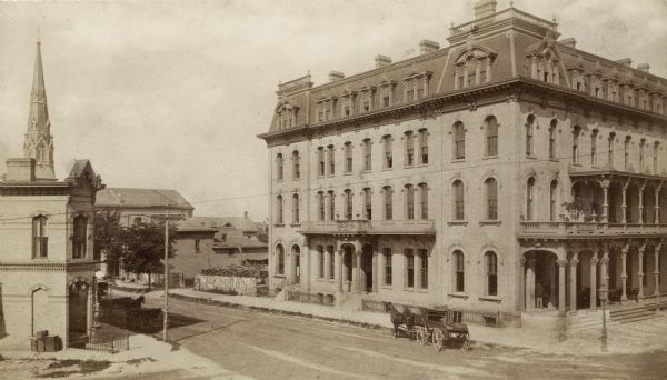 Elevated view of the exterior of the Park Hotel at Carroll and Main Streets. There is a church building in the background on the left.