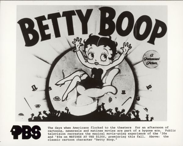 A photograph of a title card for a BETTY BOOP cartoon, showing Betty Boop sitting on the palm of a hand, surrounded by silhouettes of cheering men throwing their hats and canes in the air. "BETTY BOOP" is printed in large letters across the top while a small circle reads "A Paramount Picture."