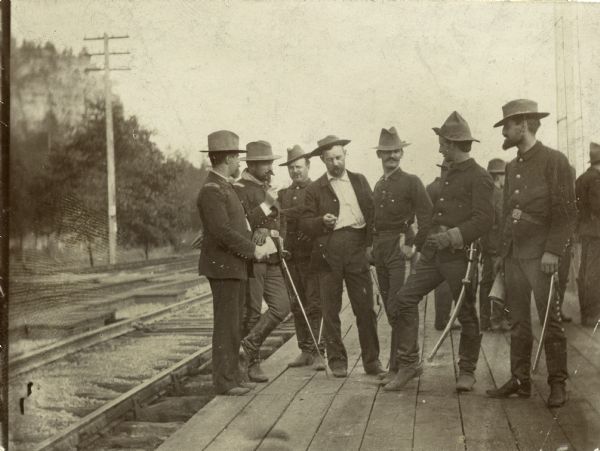 Group of Wisconsin National Guardmen standing on a platform, possibly at the Union Depot in Camp Douglas.