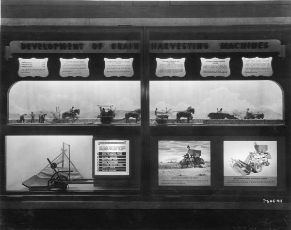 An exhibit depicting the development of grain harvesting machinery at the Northwestern University Technological Institute. The exhibit includes scale models of Cyrus McCormick's first reaper, a Marsh Harvester, a grain binder and a harvester-thresher (combine).