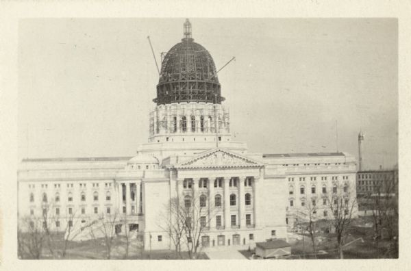 Wisconsin State Capitol Dome under Construction Elevated view of the Wisconsin State Capitol, with the dome under construction. View is looking north, towards the South Pediment. In the background on the right is the water tower on East Washington Avenue.