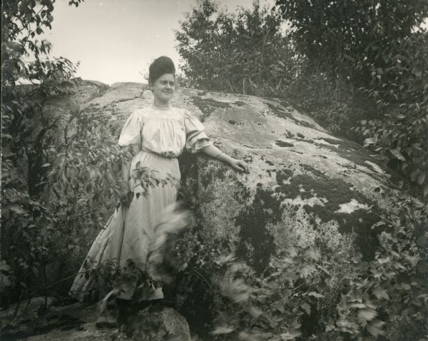 Woman Posing Near Rock, Big Falls Full-length portrait of an unidentified woman posing near a rock at or near Big Falls.