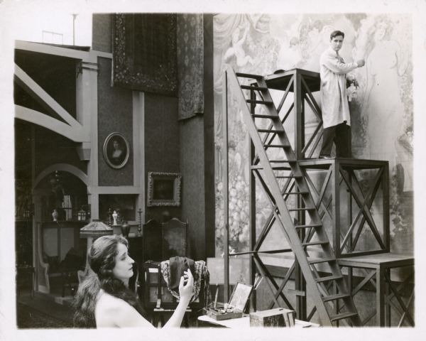 Clara Kimball Young in "The Common Law" Valerie West (Clara Kimball Young) posing nude for Neville (Conway Tearle) in the 1916 film "The Common Law." Neville is standing on a platform in front of a wall size canvas and is looking back at Valerie.