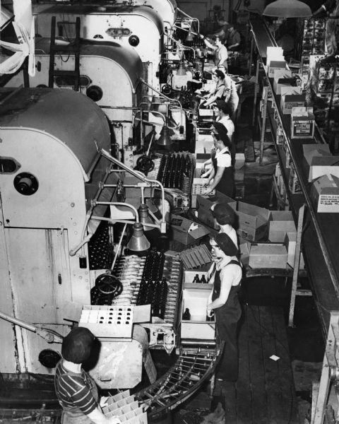 Elevated view of workers on the bottling line at the Schlitz Brewery.