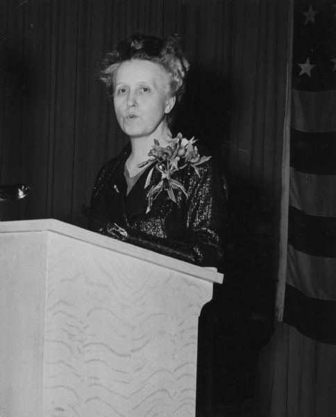 Sigrid Schultz speaks at a podium while on a lecture circuit.