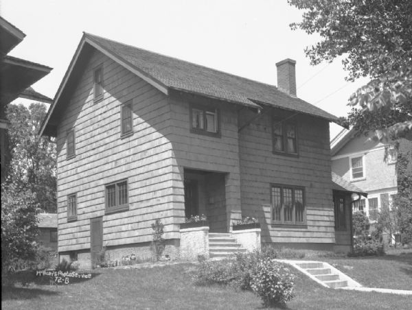 Three-quarter view from left towards the Harold K. Meyers house, at 1910 Vilas Avenue. A house is next door on the right.