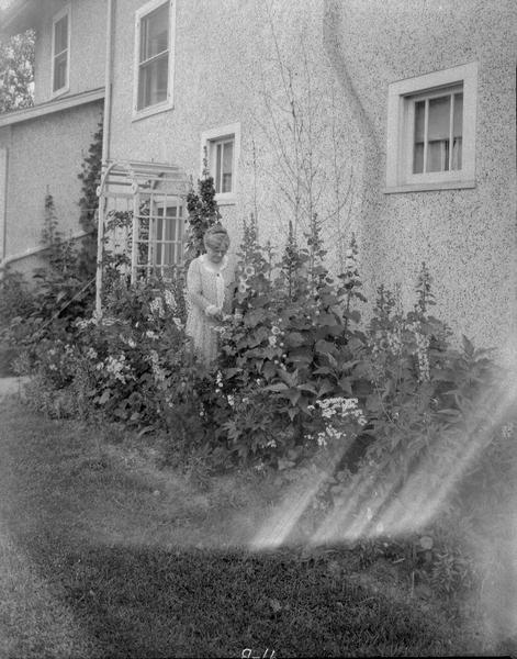 Mrs. Mary A. Maloche in garden, 138 Lathrop Street.