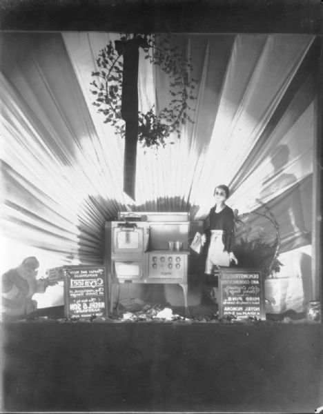 Crysteel Electric Range (stove) display at Park Hotel with mannequin and Santa Claus.