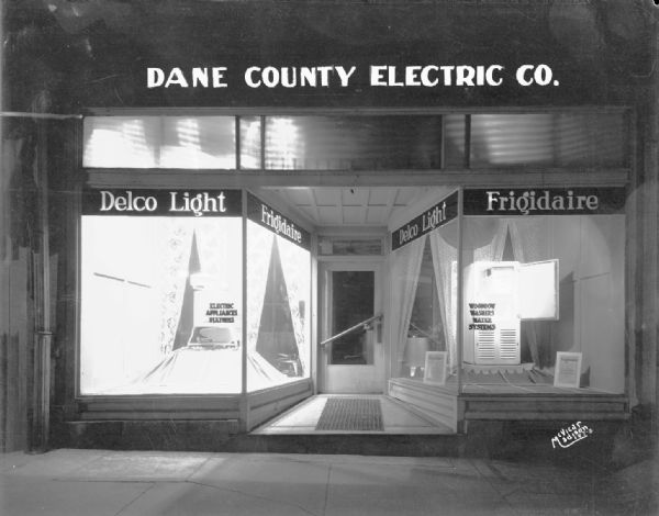 Dane County Electric Co. display window, showing a Delco Light washing machine and Frigidaire refrigerator, at 112 King Street.