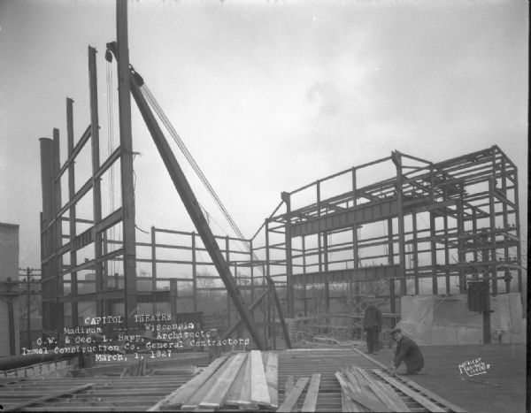 Capitol Theatre, 211 State Street, under construction. View from the roof of Kruse's store towards two workmen and the construction house.