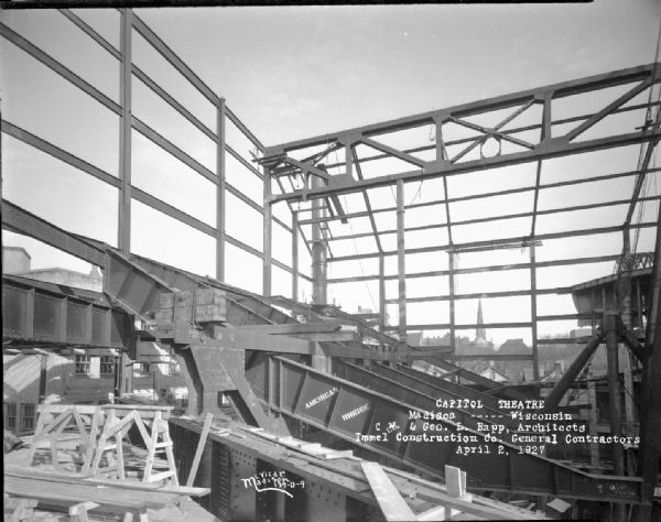 Capitol Theatre, at 211 State Street, under construction. The view is from the northwest corner toward northeast corner. American Bridge Co. sign is on the beams.