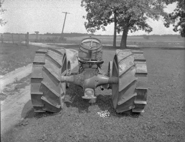 Rear view of a Fordson tractor, which has extra rims.