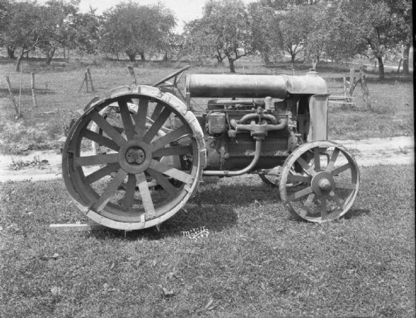 Right side view of a Fordson tractor, which has extra rims.