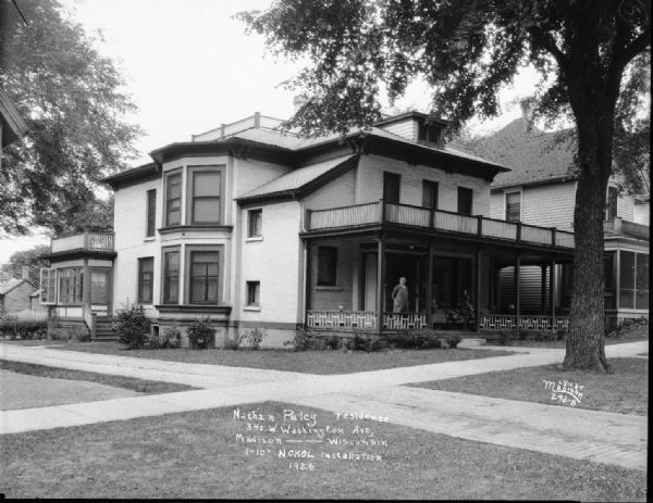 Nathan Paley House. A woman is standing on the porch of the house at 340 W. Washington Avenue.