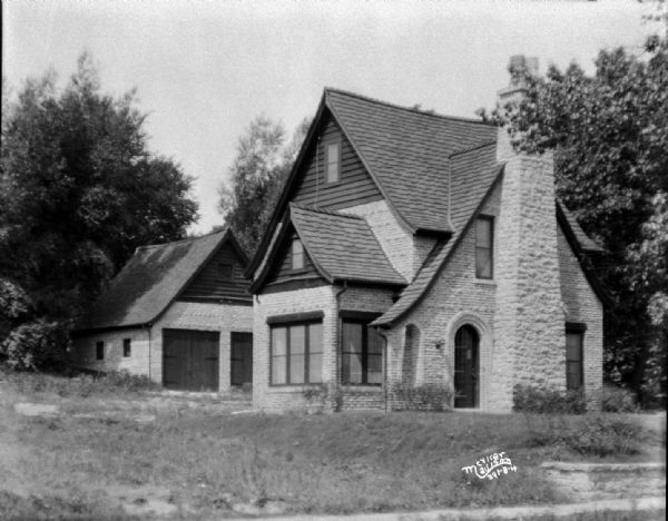 House at 454 Virginia Terrace, view across yard towards the left side. There is a garage behind the house.