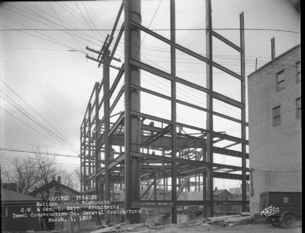 Capitol Theatre, 211 State Street, under construction. American Bridge Co. on beams, and an Esser's City Market delivery truck.
