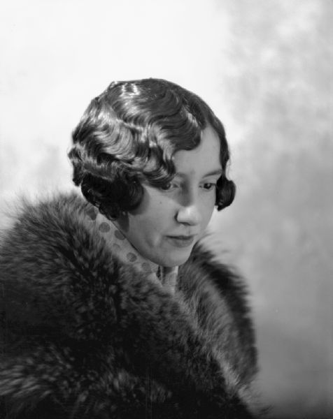 Portrait of Miss Knutson with a permanent wave in her hair. She is wearing a fur coat.