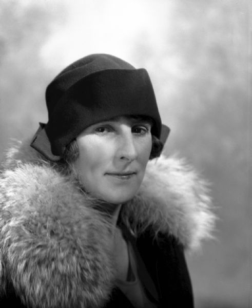 Quarter-length portrait of Miss Boese wearing a hat and a fur collar.