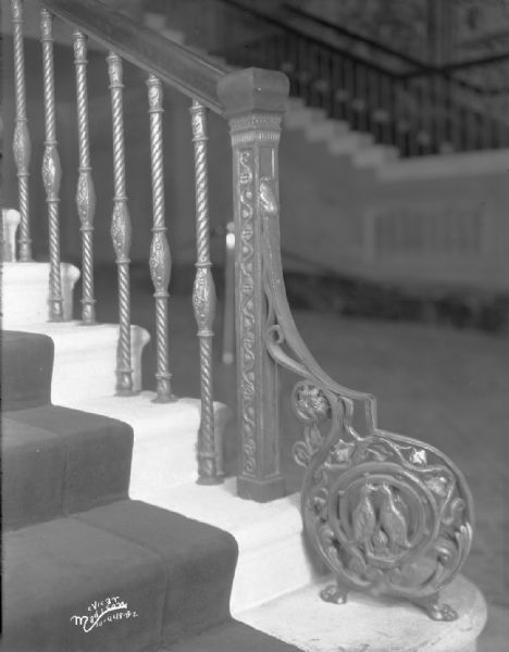 Capitol Theatre Foyer, with a close-up of banister showing ornamental scroll and newel post.