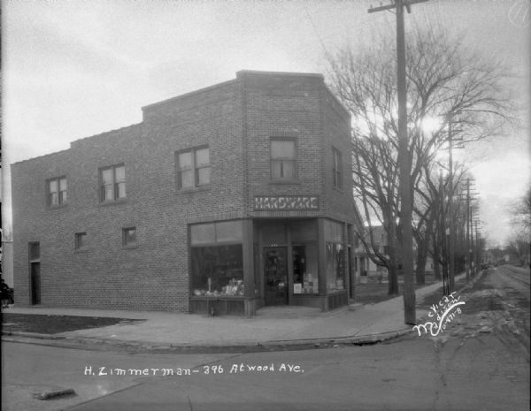 View across street towards the Herman Zimmerman Hardware Store at 2129 Atwood Avenue. Address on image reads: "396 Atwood Ave."