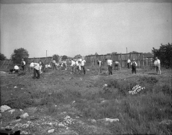 ESBMA (East Side Business Men's Association) men clearing area for playground at Burr Jones Field at 1800 E. Washington Street.