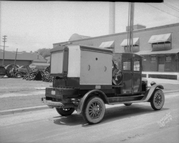 Rear view from right of a compressing machine, manufactured by Wisconsin Foundry and Machine Company, on a truck.