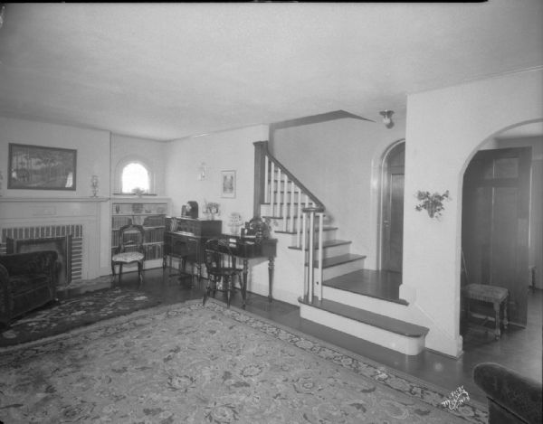 Albert Hinman Residence, 1 Vista Road. Shows the living room with fireplace, bookcases, radio, desk and stairway.