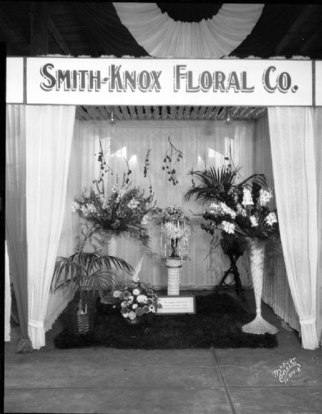 Smith Knox Floral Co. booth at East Side Business Men's Association's (ESBMA) Fall Festival at Sugar Beet factory on Sugar Avenue displaying floral displays.