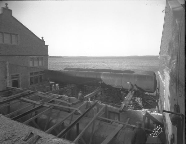 Elevated view of both tanks in place at the Hydraulics Laboratory, 660 N. Park Street, taken from upper road looking toward Lake Mendota, at the University of Wisconsin.