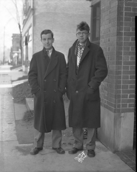 Two men standing outdoors in dress clothes. For Arthur Trowell Inc. Advertising.
