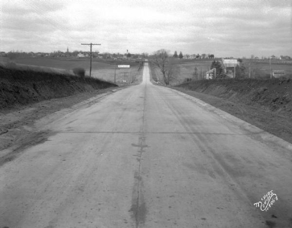 Stretch of paved rural highway featuring a proprietary centerline joint, looking towards Mount Horeb from the east.