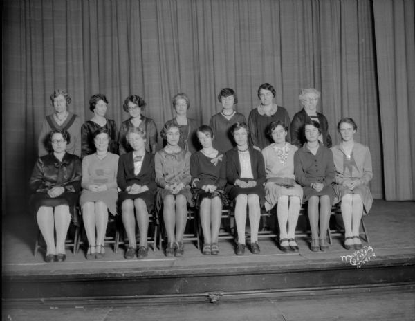 Central High School girls' club, officers and advisors group portrait, with sixteen girls and women sitting and standing.