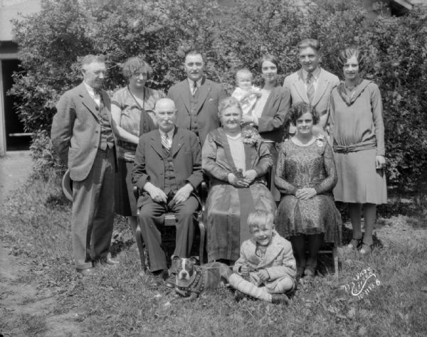 Oscar Romare family group portrait outdoors, including a dog.