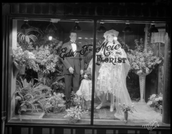 Bride and groom mannequins with floral displays in Edward F. Meier Inc. Florist "bridal window," at 542 West Washington Avenue.
