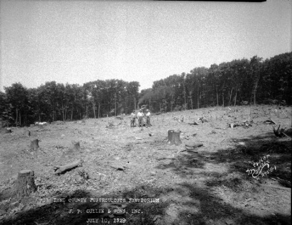 Dane County Tuberculosis Sanatorium under construction, with three men with a steam shovel clearing trees. 1202 Northport Drive. J.P. Cullen, Contractor.
