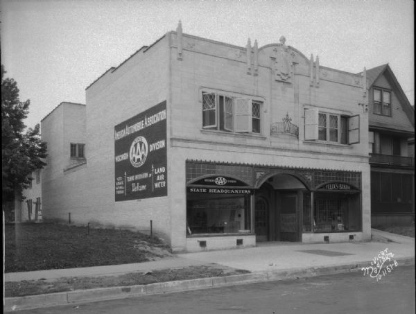 Alternate view of 715 University Avenue, showing Madison Auto Club (AAA), with AAA sign painted on the side of building, and Felix's Bakery (Felix Odehnal).