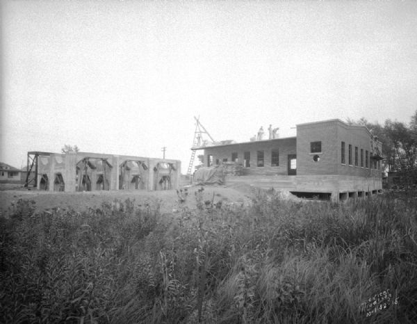 View across field towards the Carbide & Carbon Chemicals Co. Pyrofax plant under construction, 130 Fair Oaks Avenue, almost finished.