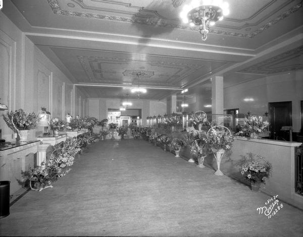 Grand opening of the State Bank of Wisconsin, State Street Branch, 502 State Street. The lobby is lined with many floral bouquets.