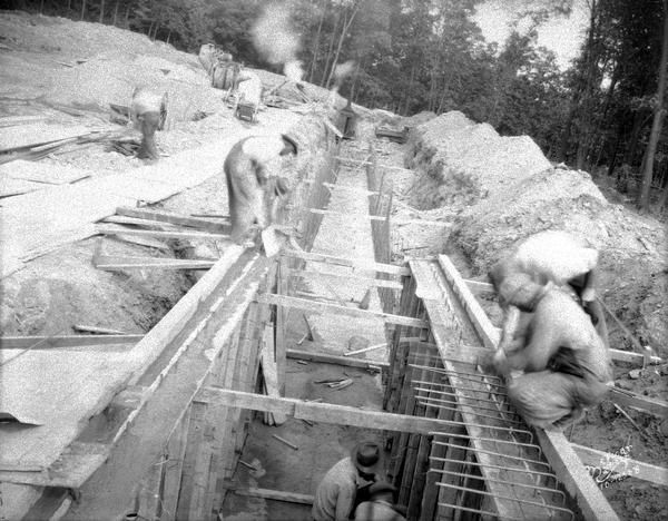 Five men are working on the heat tunnel construction for the Lake View TB sanatorium. 1202 Northport Drive.