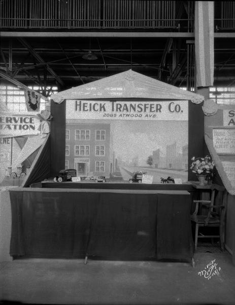 Detlev C. Heick Transfer Company, booth at ESBMA fall festival. The booth is featuring a Heick toy truck and other toy vehicles.
