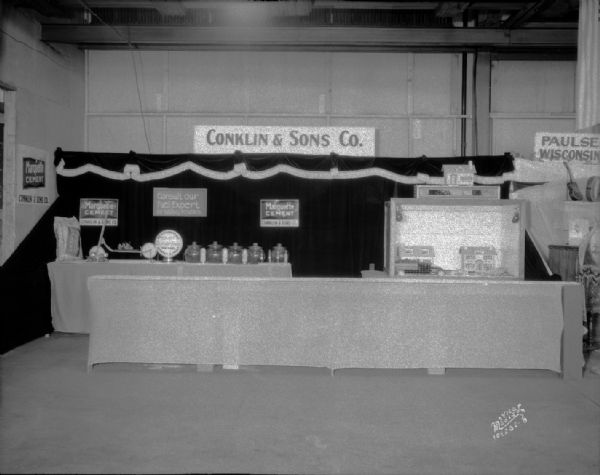 Conklin & Sons company booth at East Side Business Men's Association (ESBMA) Fall Festival. Featuring Marquette Cement, a child's scooter and Milwaukee Solvay Coke — "The Fuel Without a Fault."