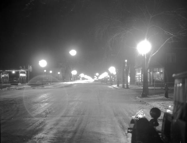 New street lights at night at the corner of S. Park Street, Vilas Avenue, and W. Washington Avenue. Looking South on Park Street. An automobile is in the right foreground.
