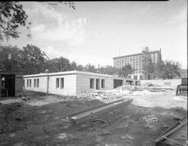 View of foundation for lower loading dock, looking northwest. The Beavers Insurance Building, at 119 Monona Avenue, is in the background.