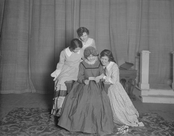 Scene from Central High School play "Little Women" with four women posing together.