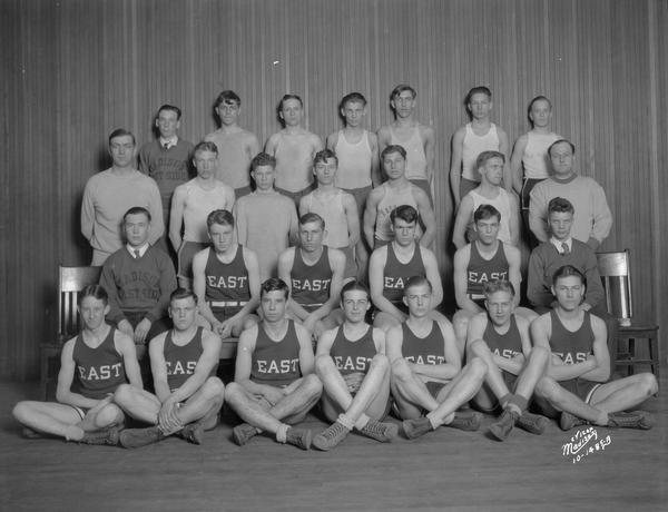 Group portrait of East High School basketball team.