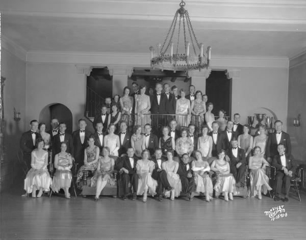 Group portrait of men and women at the Acacia fraternity spring formal.