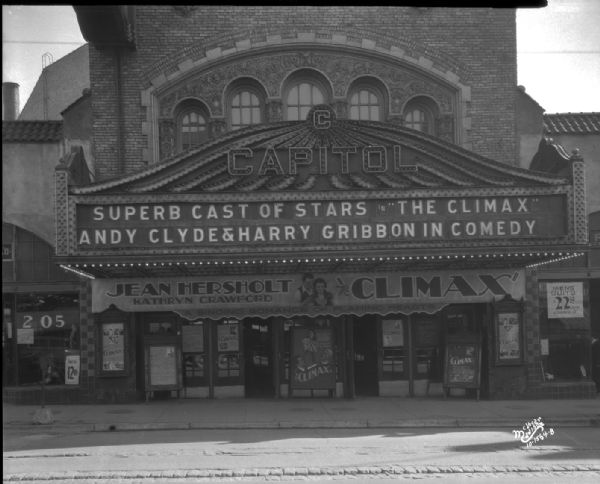 Capitol Theatre marquee reads: "Superb Cast of Stars in 'The Climax' featuring Andy Clyde, Harry Gribbon, Jean Hersholt and Kathryn Crawford, A singing romance of flaming hearts."